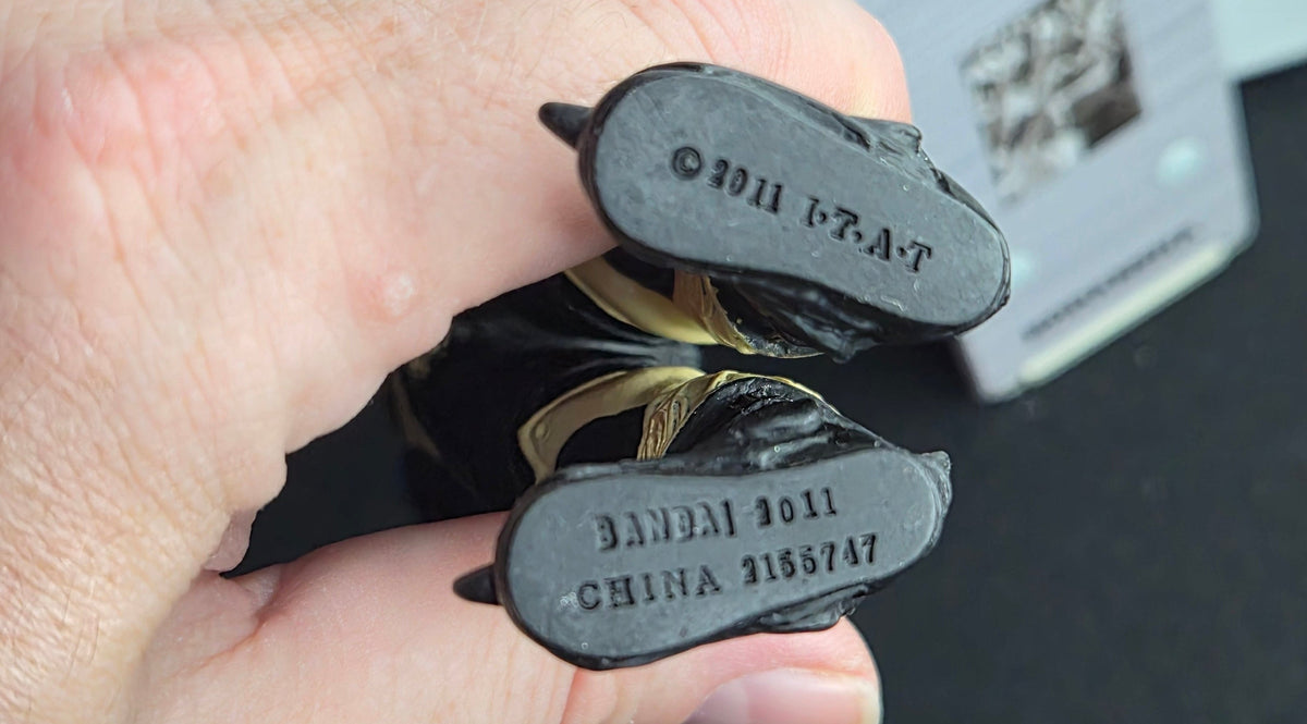 Two brake pads held between fingers with visible branding and text. 2011 Bandai Scorpion Zodiarts Sofubi Figure – Kamen Rider Fourze – 7" Tokusatsu Kaiju