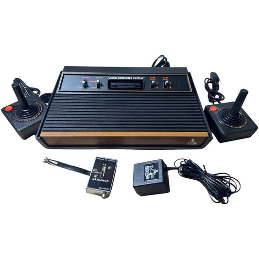Vintage video game console with controllers and accessories on a white background