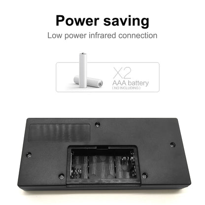 Black rectangular battery compartment cover with an open slot showing internal contacts, shown on a white background with text reading 'Power saving' and 'Low power infrared connection,' plus a small inset indicating two AAA batteries are not included.