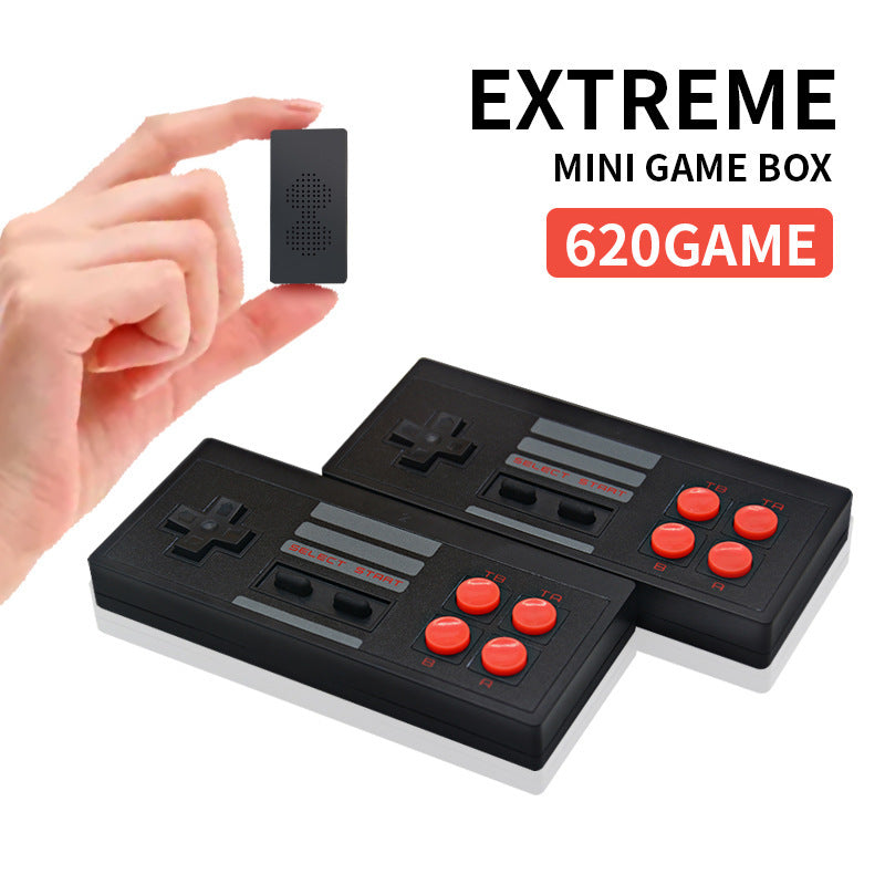 Hand holding a small black electronic device with 'EXTREME MINI GAME BOX 620GAME' text on a white background.