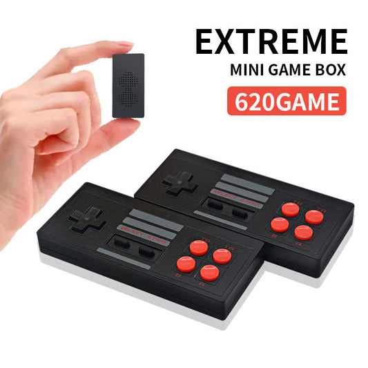 Hand holding a small black electronic device with 'EXTREME MINI GAME BOX 620GAME' text on a white background.
