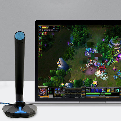 Gaming setup with a monitor displaying a game, a microphone, and a gray background.