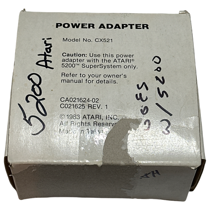 Vintage Atari 5200 power adapter box (Model CX521) showing original packaging with product label, model number, and signs of vintage wear and handwritten markings.