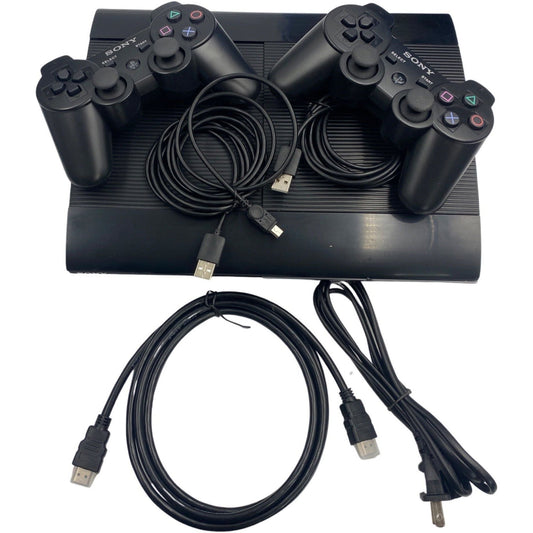 Black gaming console with controllers and cables on a white background