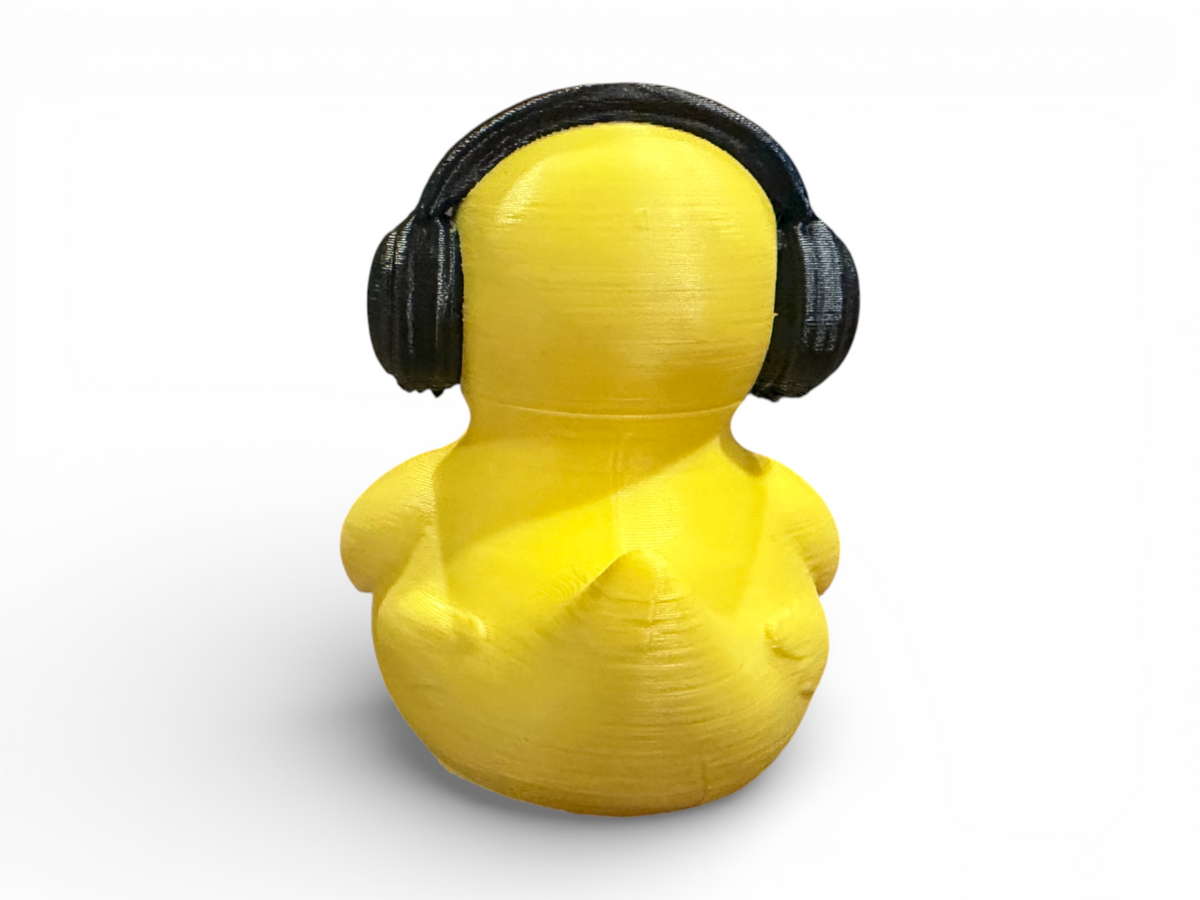 A bright yellow 3D-printed duck figure wearing black over-ear headphones, shown from the back on a clean white background.
