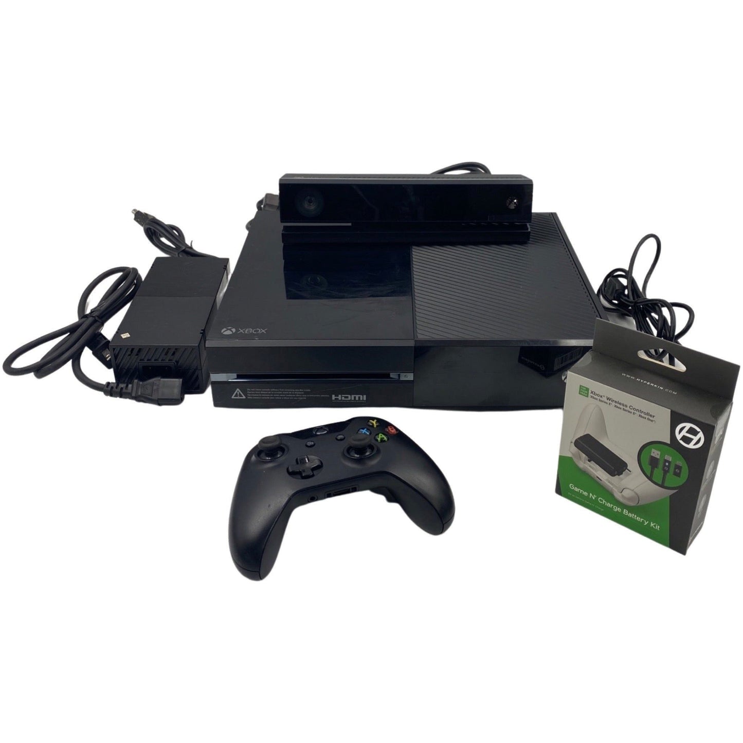 Black gaming console with controller and accessories on a white background